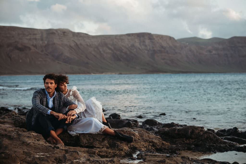 A wedding couple sitting at the beach after their Tenerife Wedding
