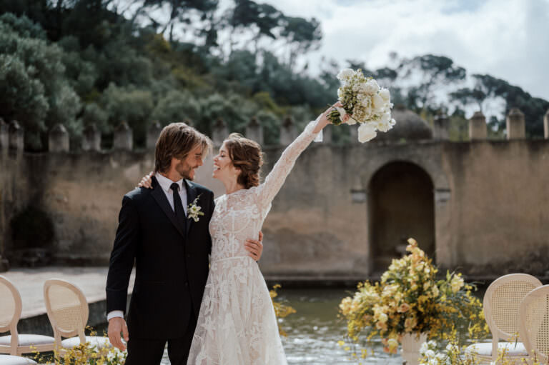 couple walking with flowers in the air in Portugal