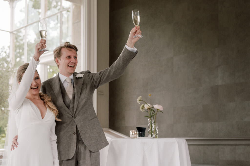 couple raising champagne glasses to toast on their wedding