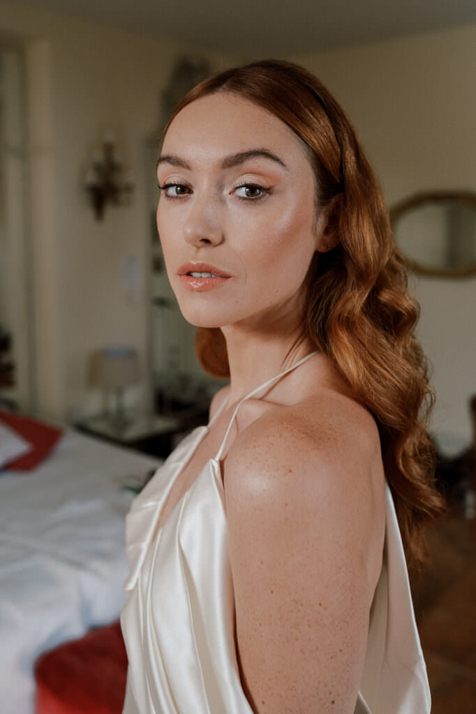 bride looking in the camera just after having make up done