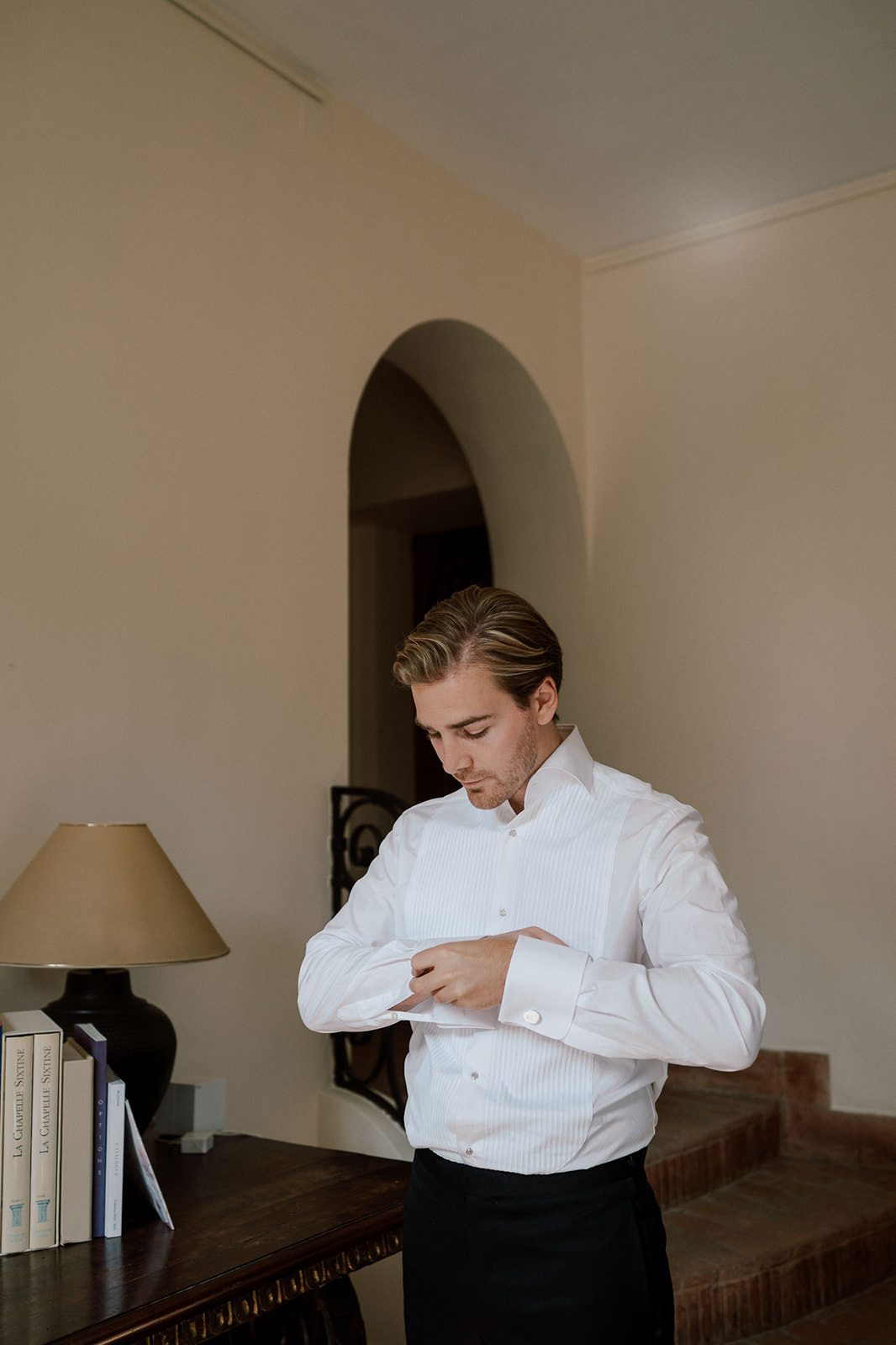 Groom putting on cufflings