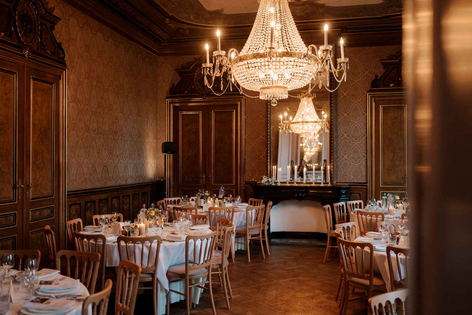 Elegant wedding reception setup in a historic ballroom with chandeliers, wedding photography services