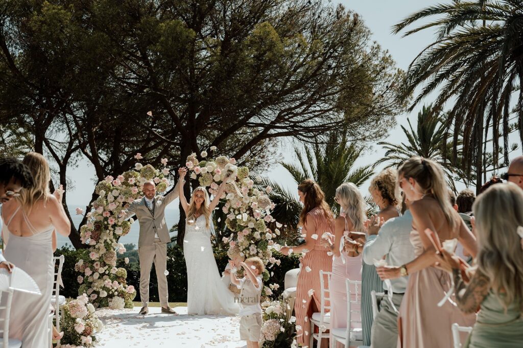 couple cheering after the outdoor ceremony in spain, wedding photographer